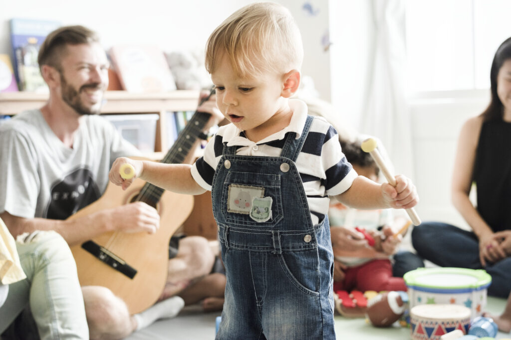 Nursery Children Playing With Musical Instruments Classroom